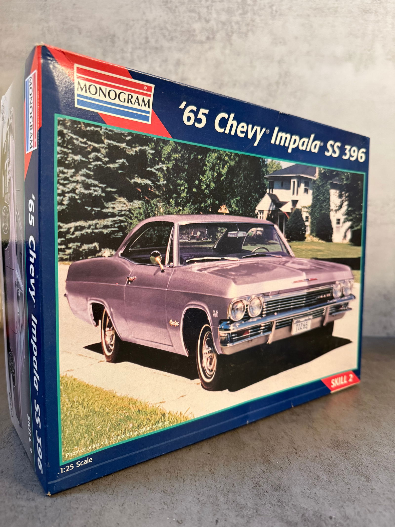 Monogram 1:25 Scale Model Kit – 1965 Chevy Impala SS 396: A boxed Monogram plastic model kit of the classic 1965 Chevrolet Impala SS 396, produced in 1:25 scale.The kit appears to include molded plastic body parts, clear plastic components, wheels, and acces