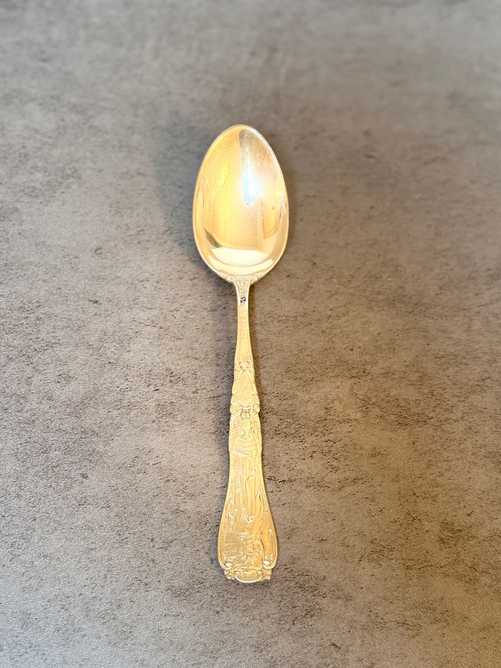 Tiffany & Co. Sterling Silver Statue of Liberty Souvenir Spoon, 1.4 ozt: A sterling silver souvenir spoon by Tiffany & Co. featuring a detailed figural handle depicting the Statue of Liberty above an eagle motif. Marked TIFFANY & CO. STERLING to the reverse. A collectible