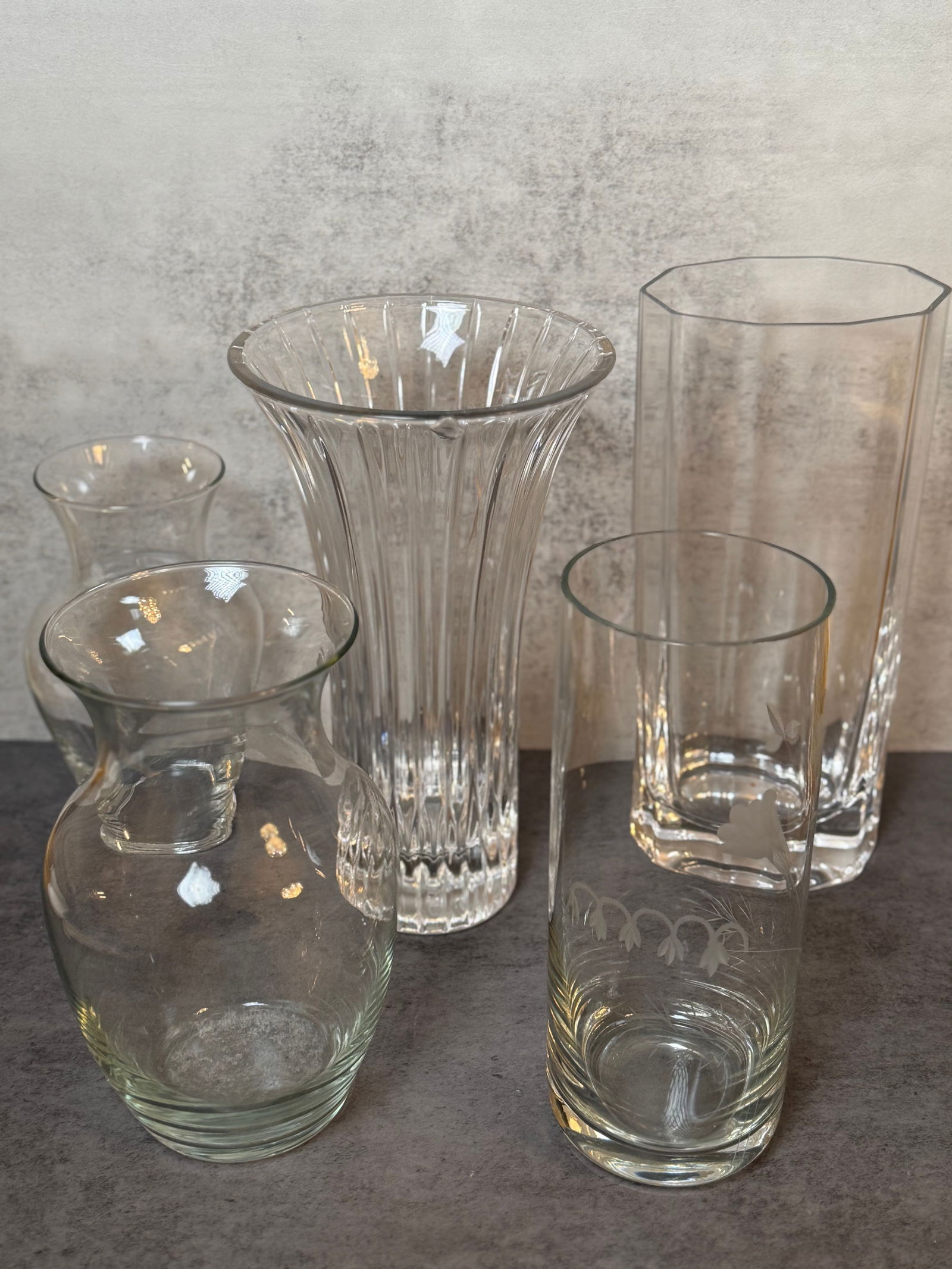 Assorted Decorative Glass Vase Group: An assorted group of five decorative glass vases in various forms including fluted, cylindrical, and baluster examples. Suitable for decorative display.
