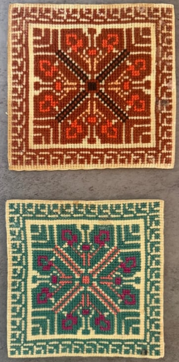Two Vintage Needlepoint Embroidery Textile Panels with Geometric Folk Motif: A pair of vintage hand-stitched needlepoint textile panels featuring geometric folk-style motifs.Each piece is worked in wool threads on an open canvas ground with vibrant colors including rust red,