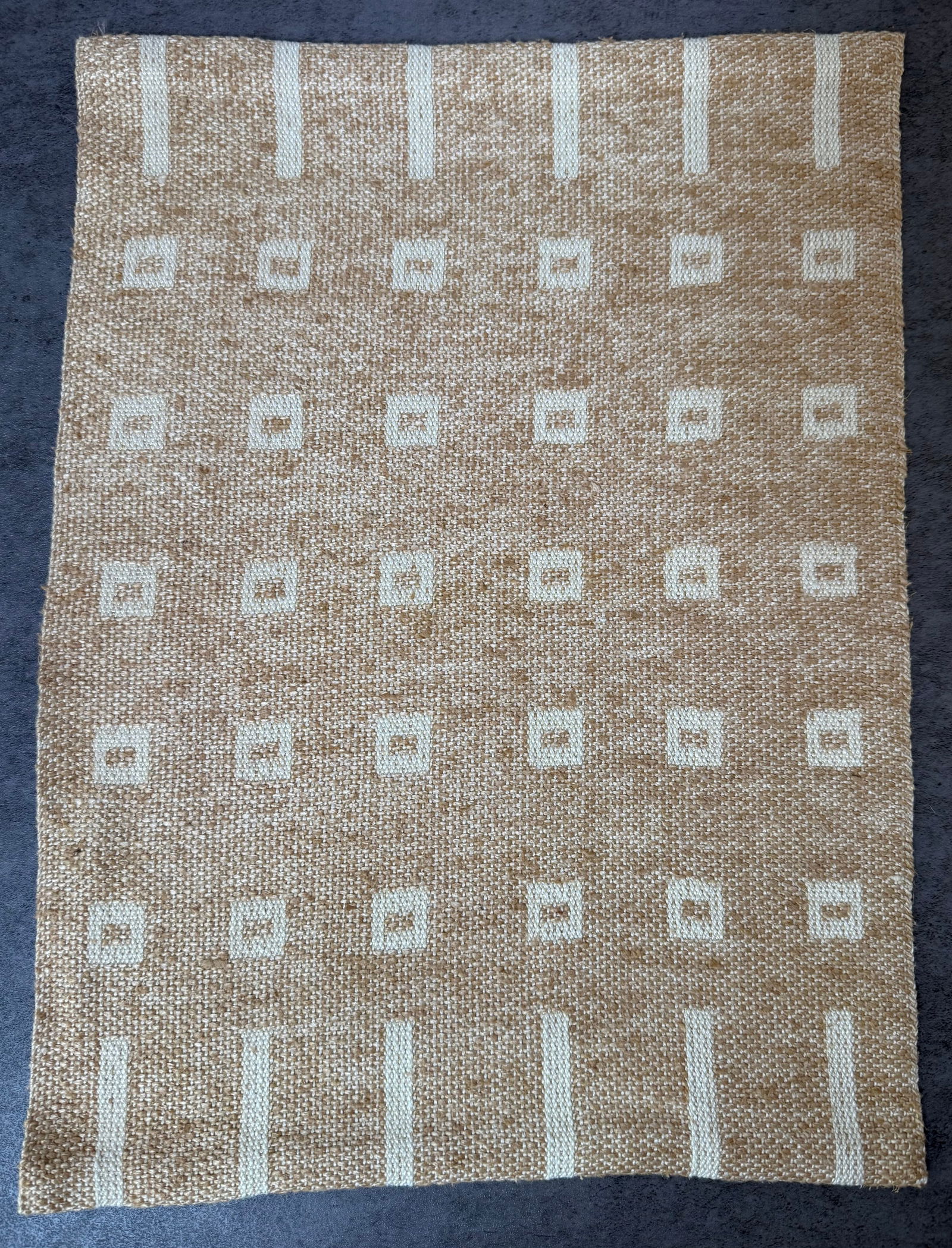 Vintage Woven Linen Textile Table Mat with Geometric Pattern, 11 x 15 in: A vintage woven linen textile table mat featuring a subtle geometric pattern composed of small square motifs arranged in a grid. The design is created through the weaving process rather than