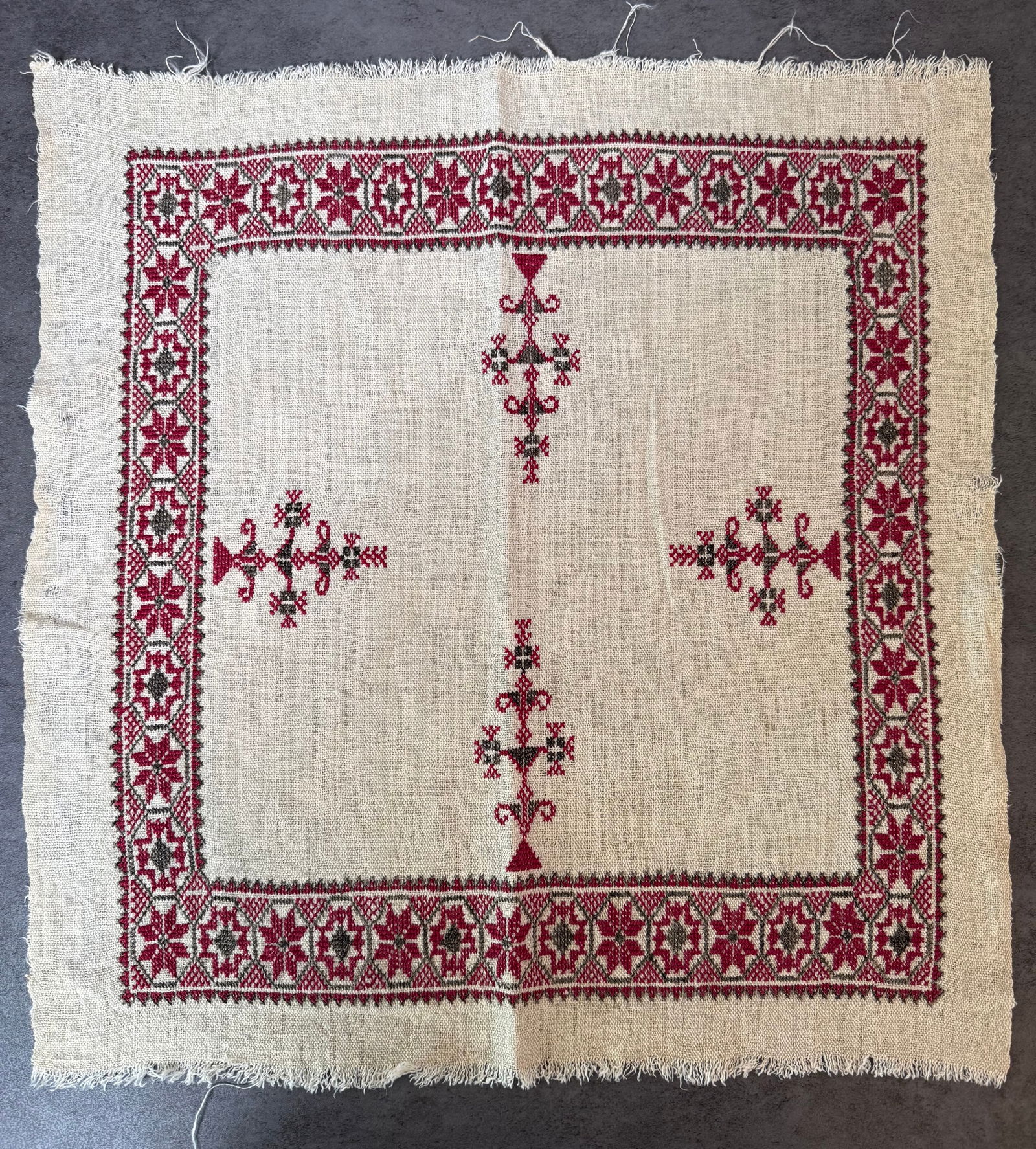 Vintage Eastern European Hand Embroidered Linen Textile Folk Table Mat, 16.5 x 17 in: A vintage hand-embroidered linen textile featuring traditional Eastern European folk motifs. The design is executed in red and dark thread using cross-stitch techniques on natural linen.The piece