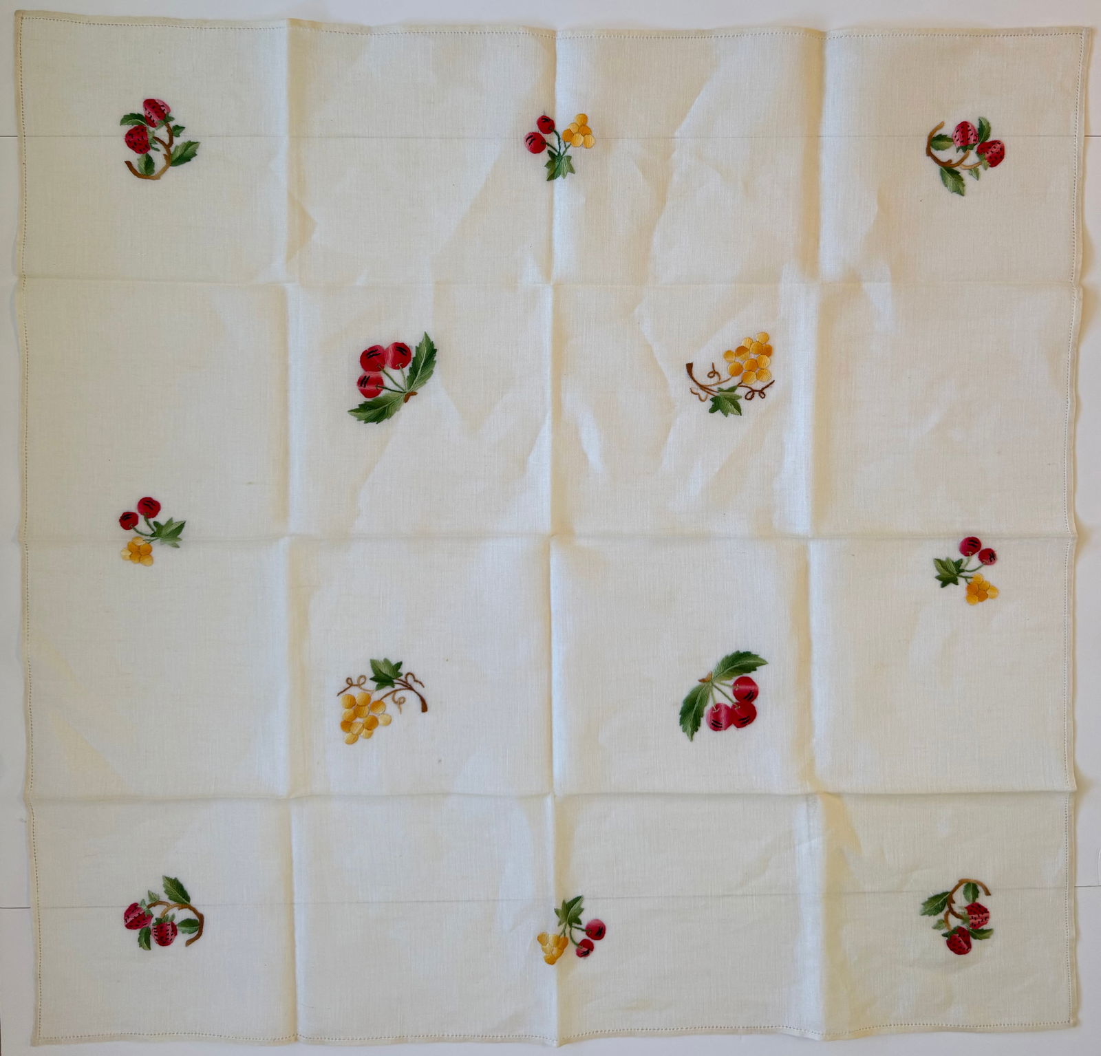Vintage Hand Embroidered Linen Tablecloth with Fruit Motifs, 32 x 33 in: Vintage linen tablecloth featuring hand embroidered fruit motifs including strawberries, cherries, and grapes arranged across the natural linen field. Decorative mid-century European household