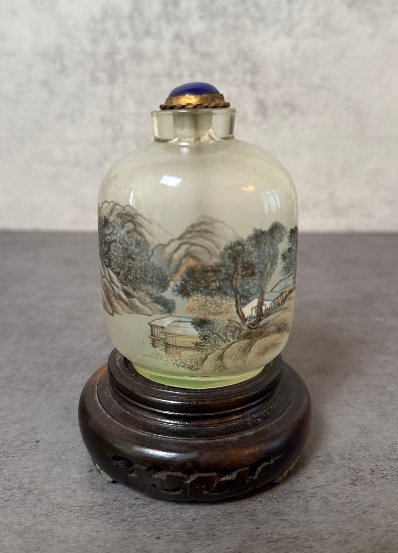 Chinese Inside Painted Glass Snuff Bottle with Landscape Decoration: Chinese inside painted glass snuff bottle decorated with finely detailed landscape scenery. The bottle is painted internally with traditional Chinese motifs including mountains, trees, and a pavilion