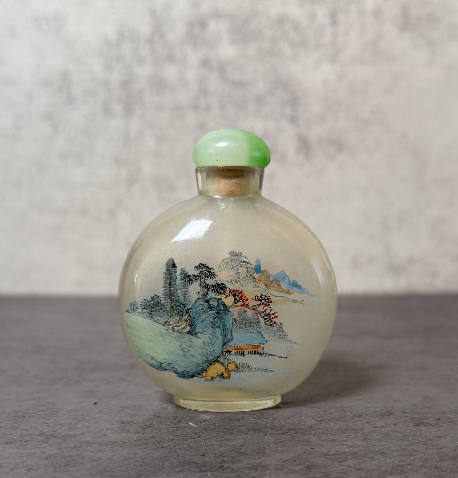 Chinese Inside Painted Glass Snuff Bottle with Floral Decoration: Chinese inside painted glass snuff bottle decorated with a finely rendered floral composition including orange blossoms and foliage beside a scholar’s rock. The reverse side depicts a traditional la