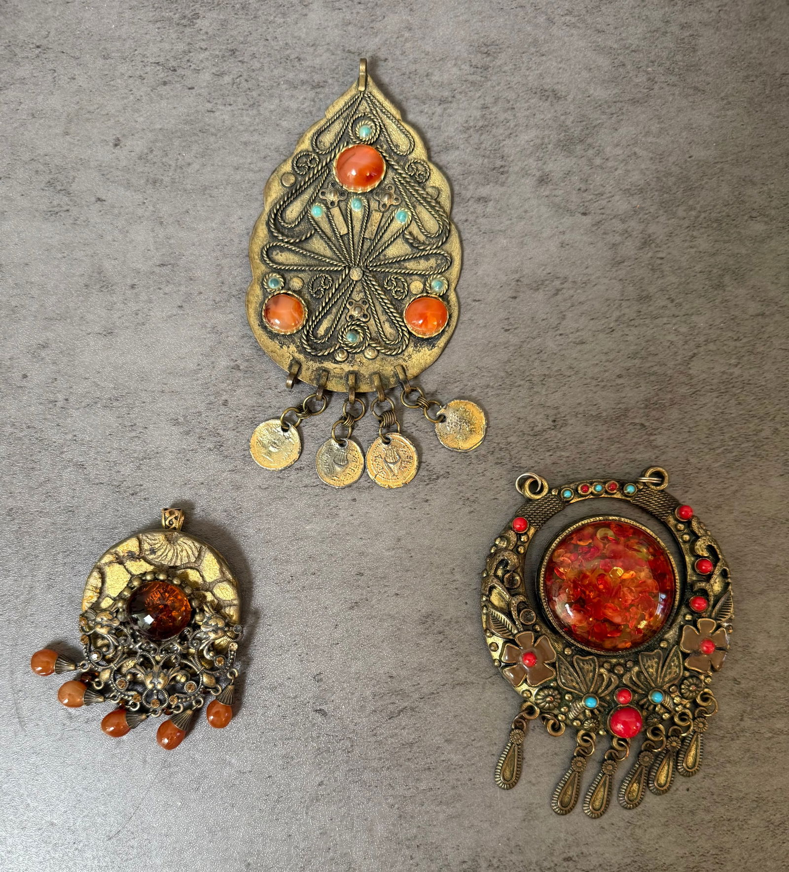 Lot of 3 Large Vintage Tribal Ethnic Pendants: A striking trio of large decorative tribal pendants, each showcasing the bold ornamentation and rich warm tones characteristic of Central Asian, Middle Eastern, or North African jewelry traditions. Al