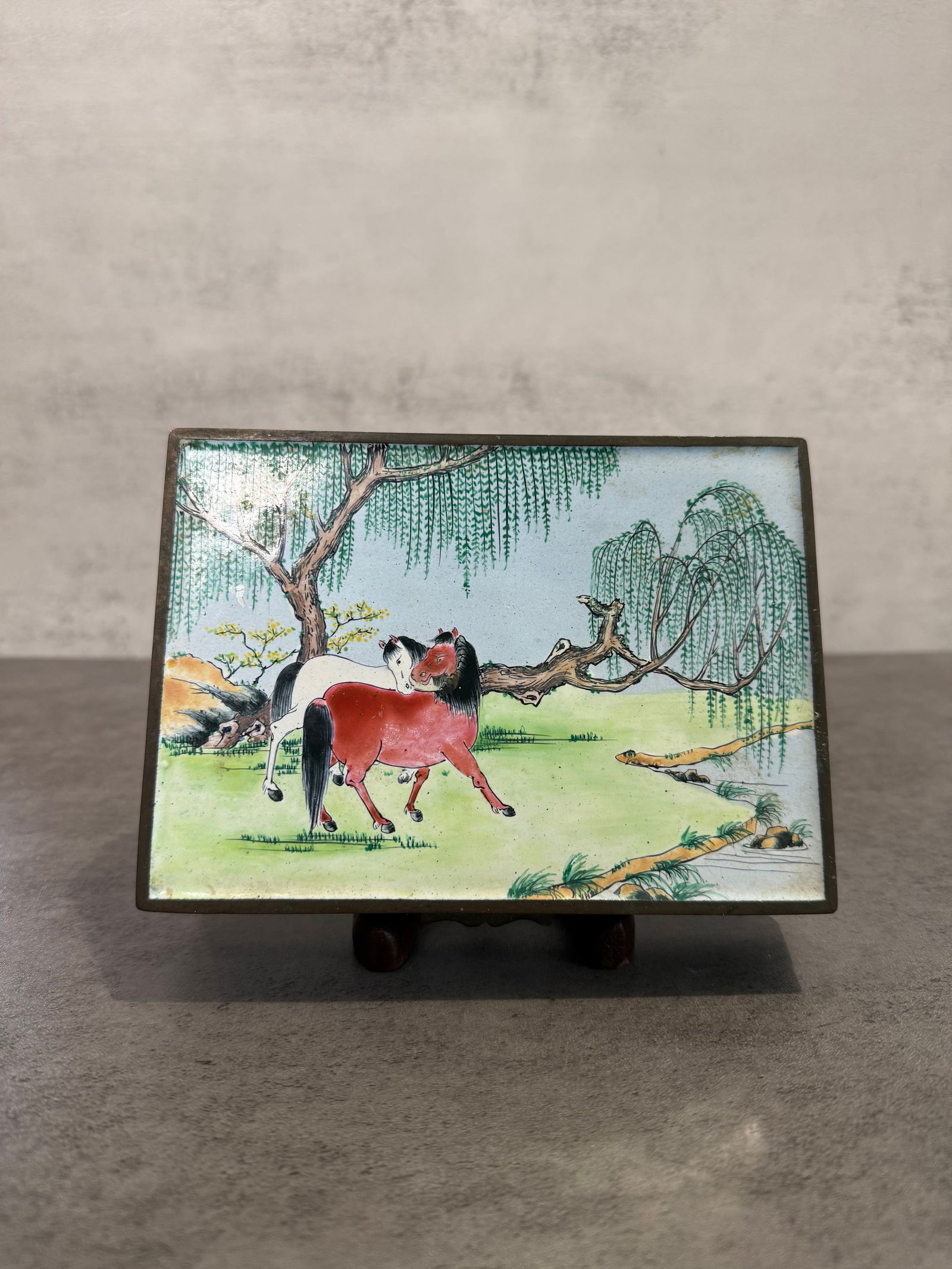 Antique Chinese Canton Enamel Box, Horses Under Willow, Bird and Bamboo: A Chinese painted Canton enamel rectangular box. The cover decorated with two horses beneath willow and blossoming trees in a river landscape. The sides painted with a bird perched among bamboo on a