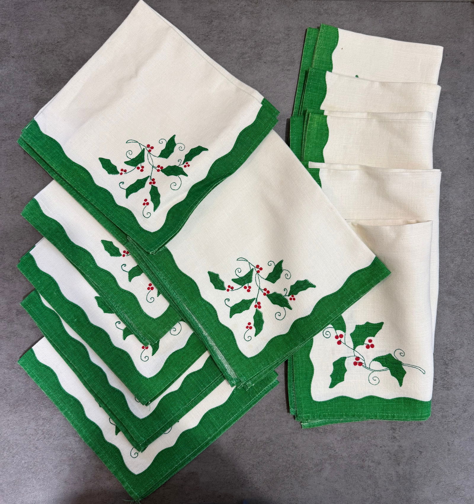 Vintage Christmas Holly Embroidered Linen Napkins, Set of 12: A set of twelve ivory linen napkins with green border trim and embroidered holly and red berry motif. Classic Christmas holiday design.