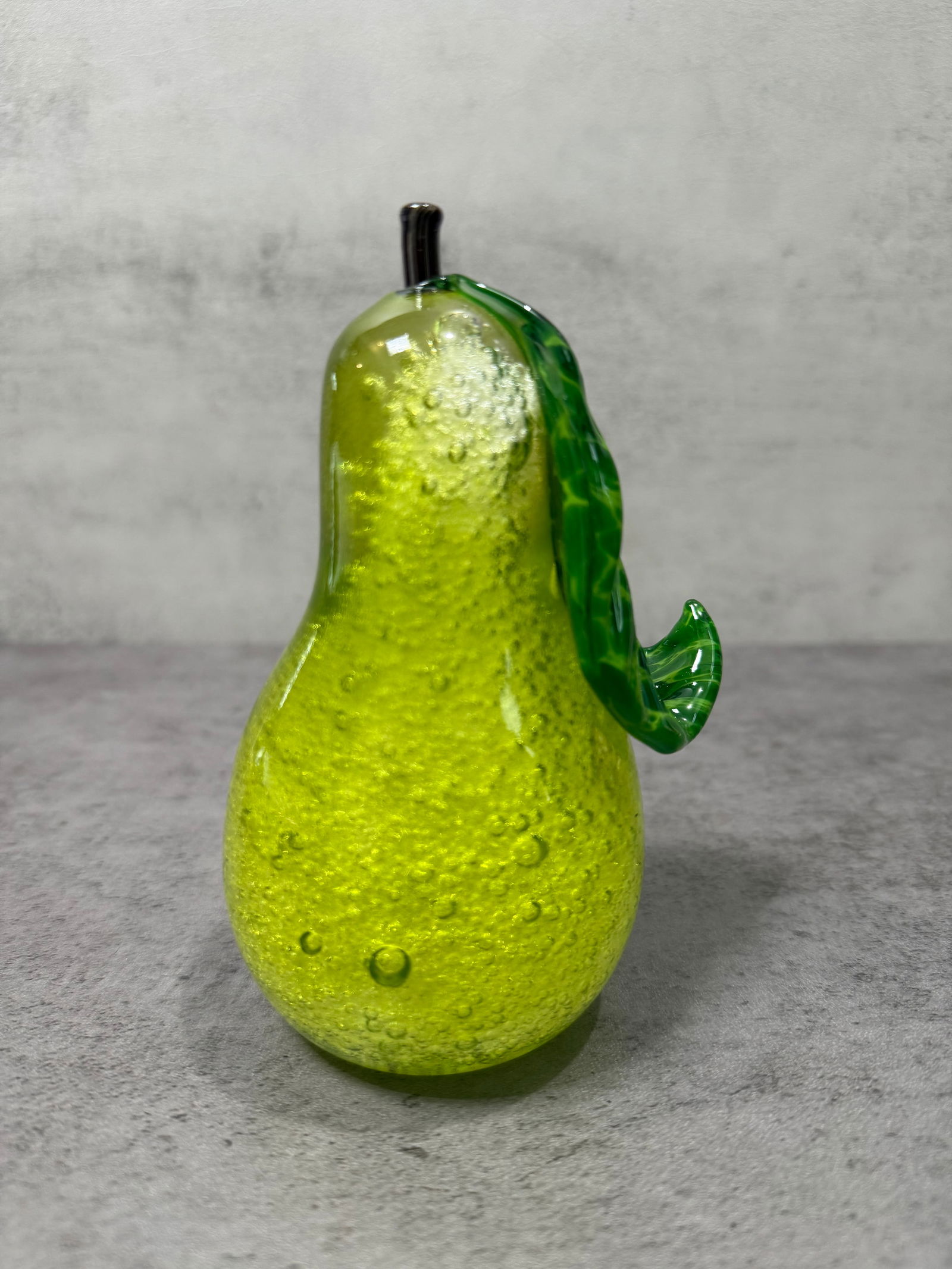 Art Glass Green Controlled Bubble Blown Glass Pear Figurine Paperweight: Decorative blown art glass pear in vivid chartreuse/lime green with controlled bubble technique throughout. Features a dark metal stem and applied green glass leaf. Heavy, solid form with excellent
