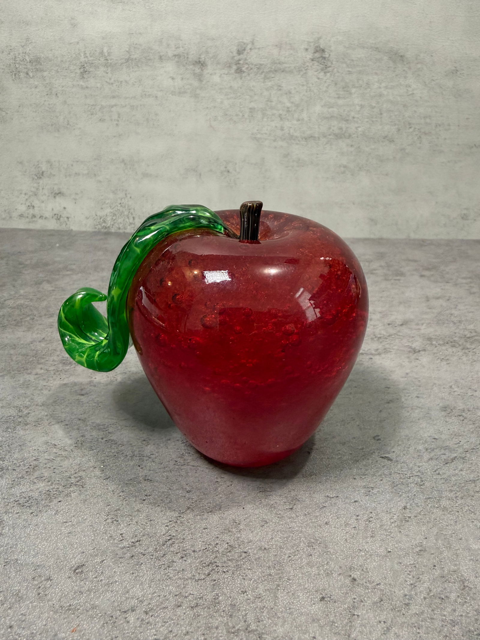 Art Glass Red Blown Glass Apple Figurine Paperweight Green Leaf Murano: Decorative blown art glass apple in deep ruby red with applied green glass leaf and dark metal stem. Solid, heavy form with excellent color depth and light refraction. Murano-style craftsmanship.