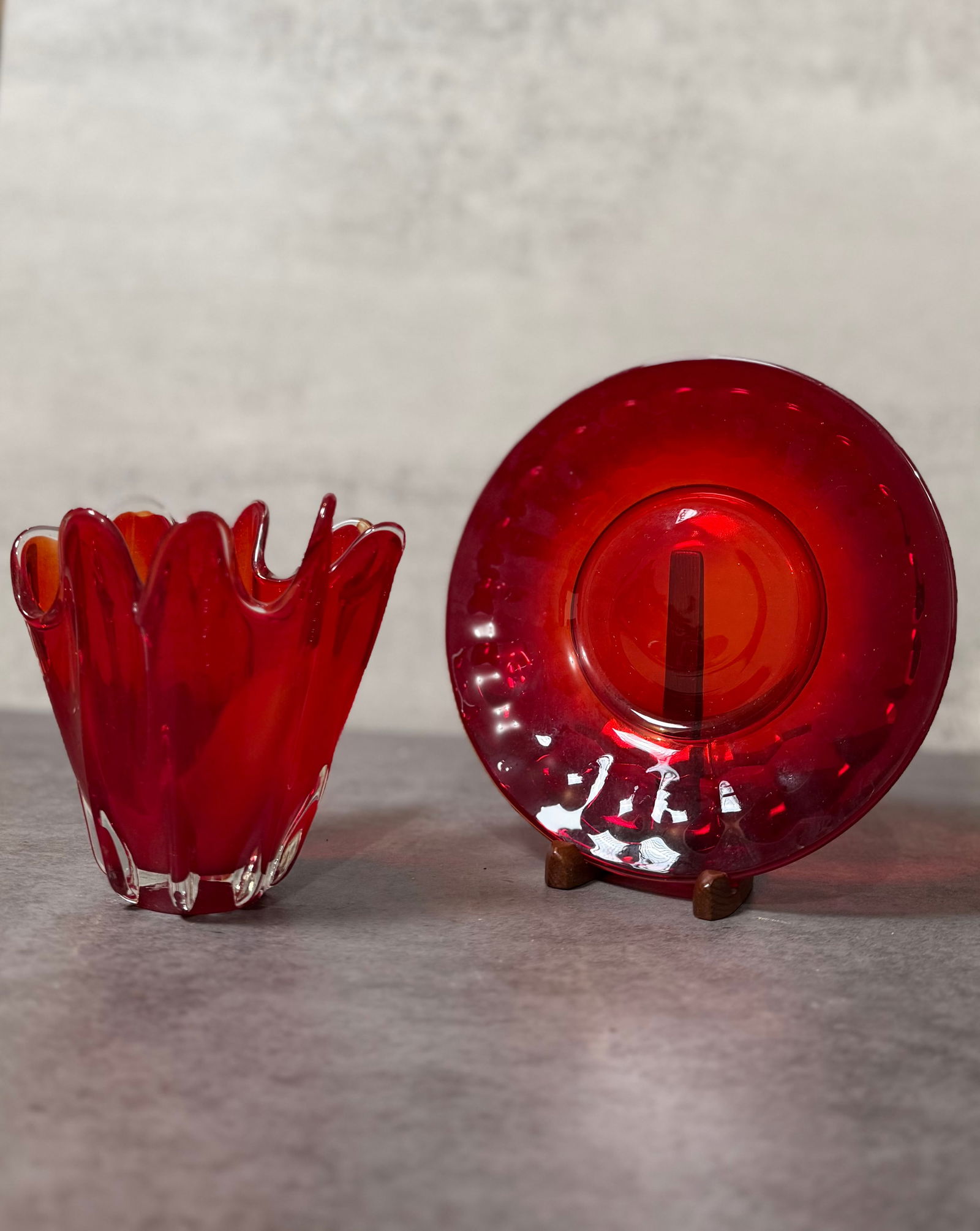 Vintage Ruby Red Art Glass Vase and Plate, Freeform Crimped Edge, Decorative Set: A striking vintage art glass grouping in rich ruby red, featuring a sculptural freeform vase paired with a matching plate.The vase is formed with an expressive crimped rim, creating a fluid, organic