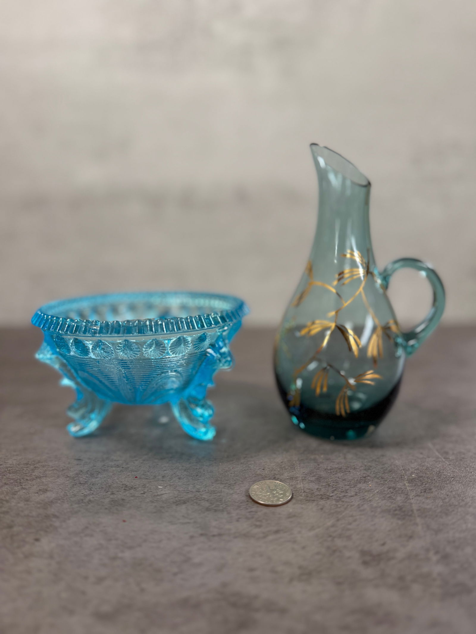 Charming Vintage Blue Glass Footed Bowl & Mini Pitcher Set, Pressed & Handled, Decorative Pair: A delightful pairing of vintage blue glass featuring a pressed glass footed bowl and a petite handled pitcher. The bowl showcases a detailed pattern with a scalloped rim and elegant tripod feet,