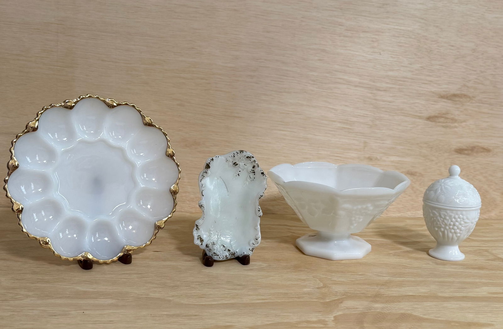 Elegant Vintage Milk Glass Serving & Decorative Group, Gilt Rim Dish, Footed Bowl & Covered Jar: A refined grouping of vintage milk glass pieces featuring a harmonious white tone and varied classic forms. Includes a scalloped dish with gilt rim, a decorative tray with raised edges, a footed bowl