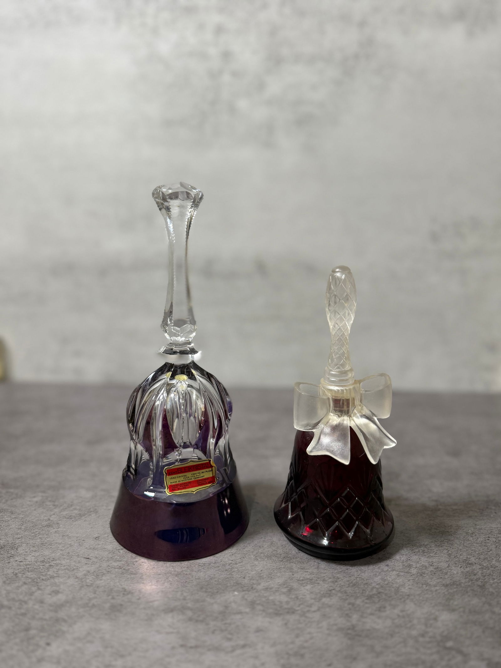Vintage Cut Glass Perfume Bottle & Ruby Glass Bell, Decorative (2 pcs): A mixed lot of two vintage decorative glass pieces, including a cut glass perfume bottle and a ruby-toned glass bell.The perfume bottle features a faceted stopper with a frosted bow motif at the neck