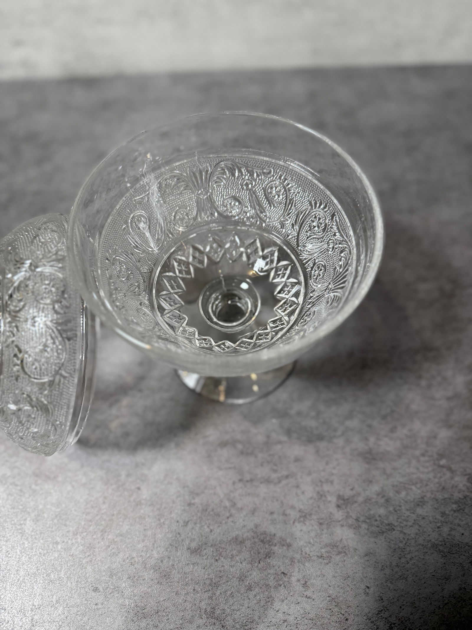 Antique Pressed Glass Covered Candy Compote Pineapple Finial Floral: This elegant clear pressed glass covered candy compote features an ornate all-over floral and foliate pattern with fine stippled backgrounds, set against a classic pedestal base with a decorative