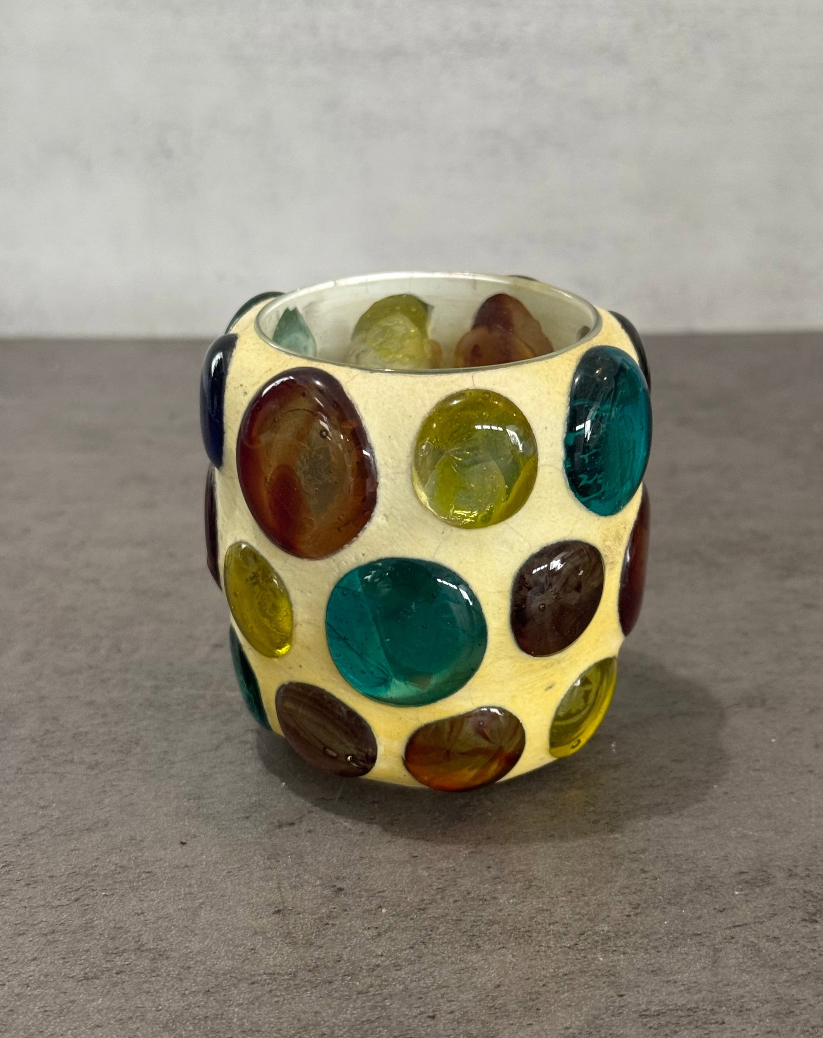 Vintage Decorative Vessel with Multicolor Glass Cabochon Design: A vintage decorative vessel featuring an exterior set with multicolored glass cabochon elements in varying sizes and tones. The rounded form is accented by the vibrant glass insets, creating a bold