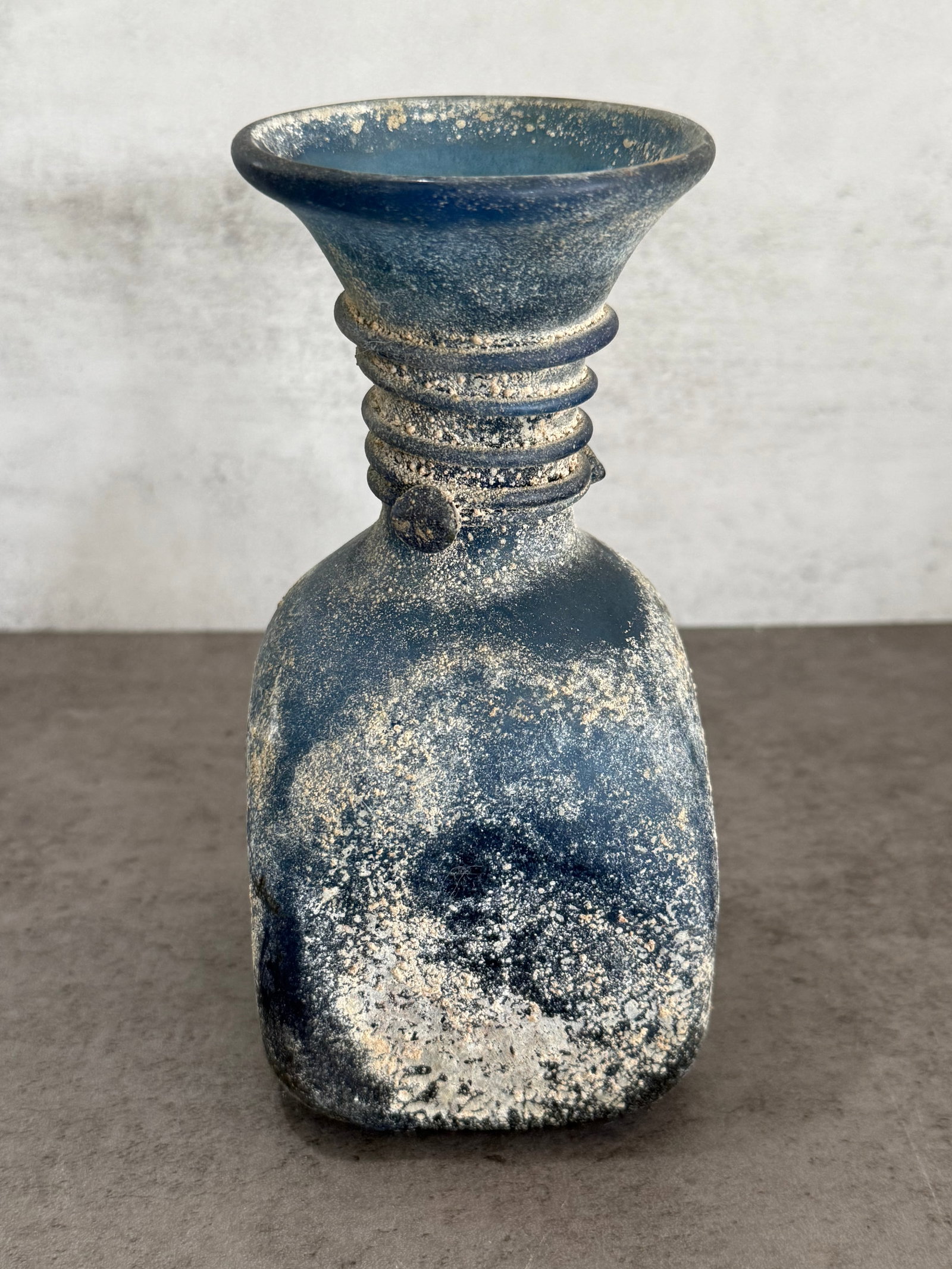 Rare Antique Cobalt Blue Art Glass Vase: Antique art glass vase of sculptural form, featuring a squared body rising to a flared neck with applied ring decoration. Executed in deep cobalt blue glass with heavily textured and weathered