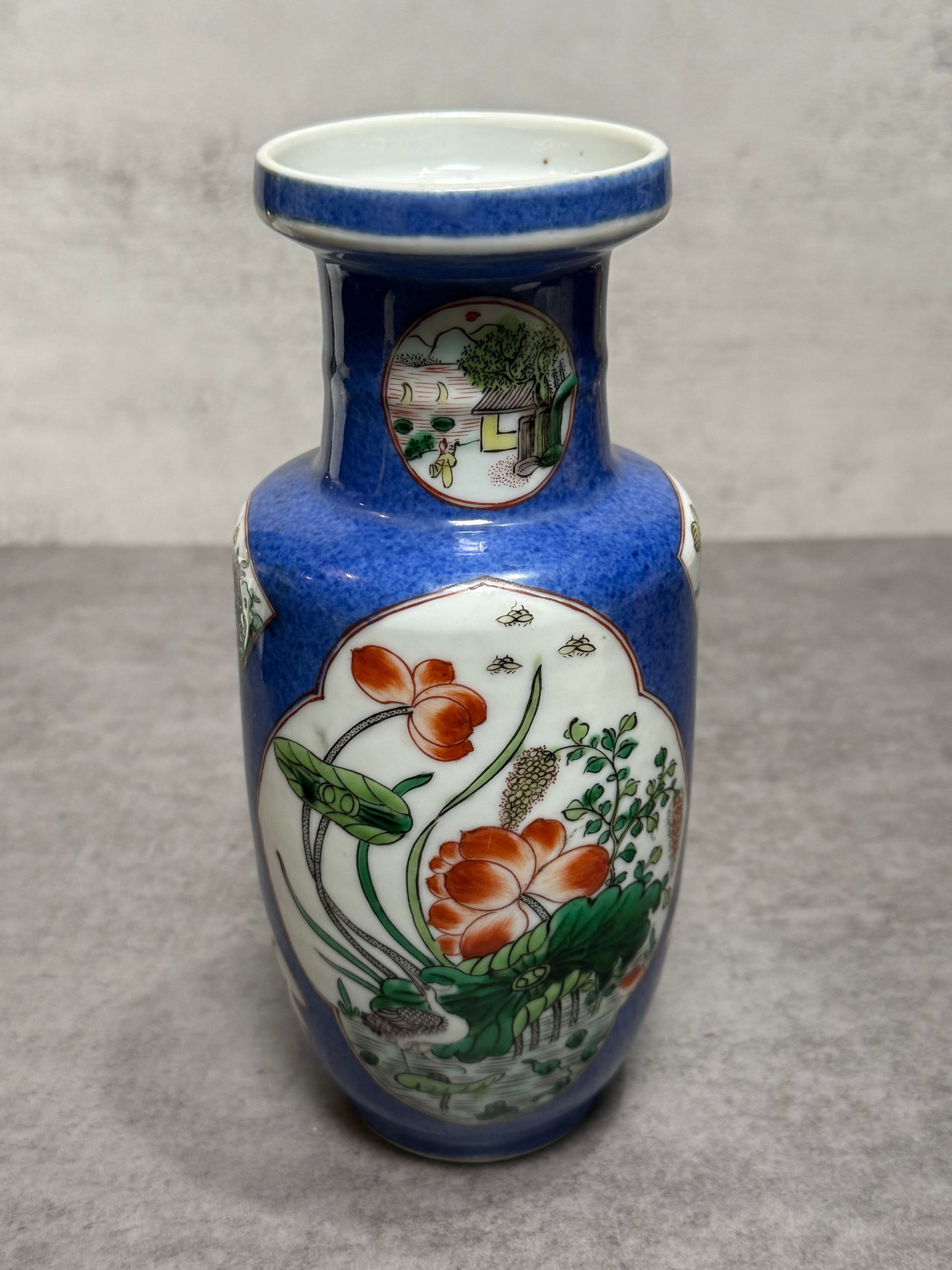 Vintage Chinese Powder Blue Ground Famille Rose Porcelain Vase: Chinese porcelain vase featuring a rich powder blue ground decorated with shaped famille rose reserve panels depicting lotus blossoms, aquatic plants, insects, and landscape scenes. The elegant
