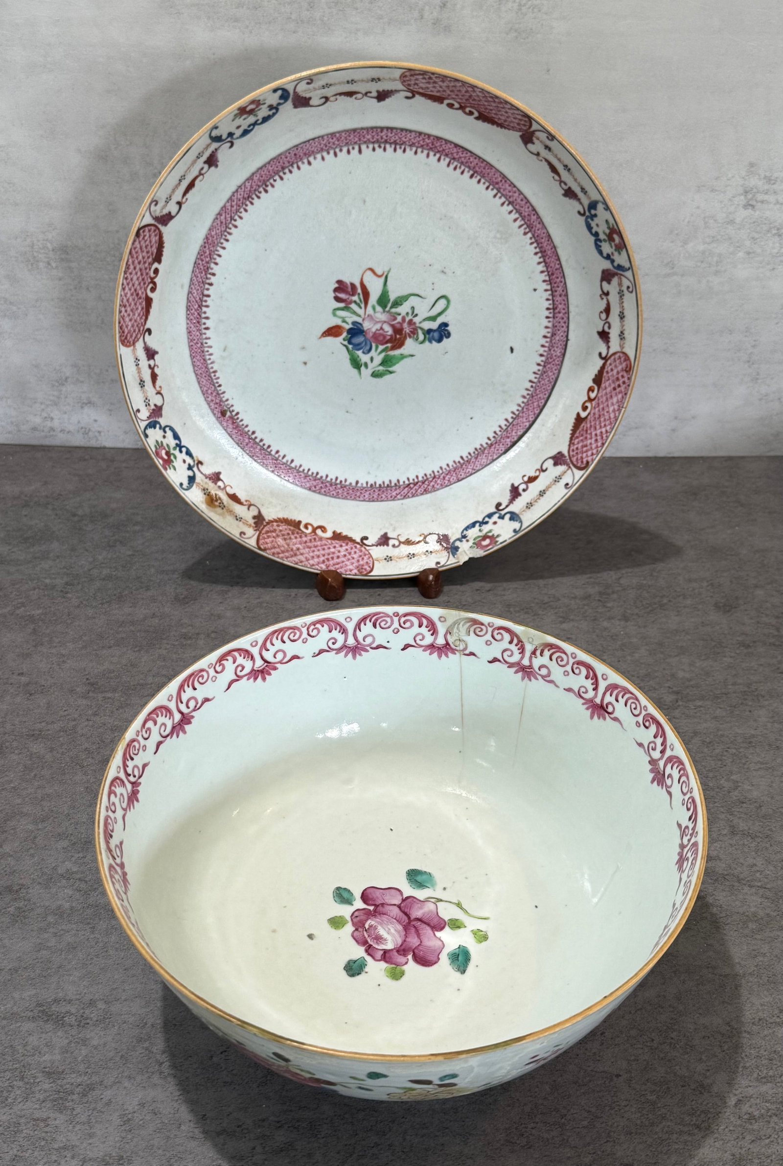 Chinese Export Famille Rose Floral Porcelain Bowl & Plate: Including a Chinese export style porcelain bowl and matching plate, each decorated with finely detailed floral bouquet medallions, scrolling iron-red border ornamentation, and delicate gilt accents.