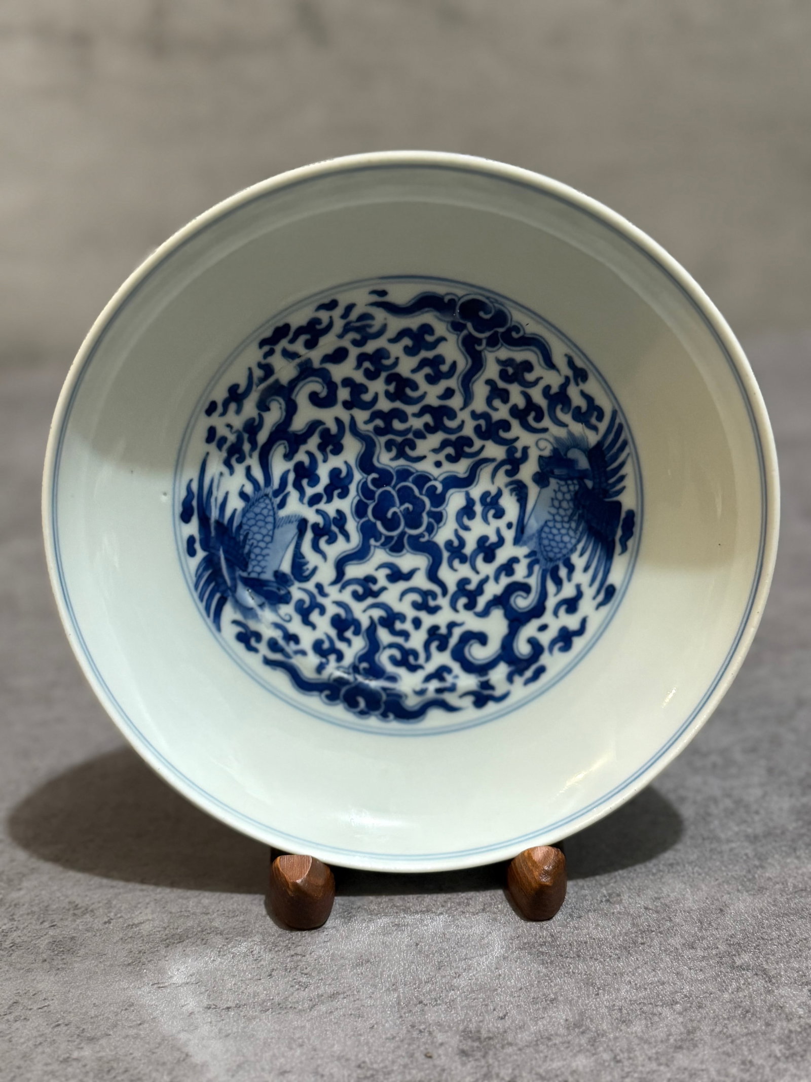 Chinese Blue and white Dish Marked: Chinese porcelain bowl decorated in underglaze cobalt blue with cranes amidst scrolling clouds and floral motifs to the interior medallion. The bowl features a clean white ground with finely painted