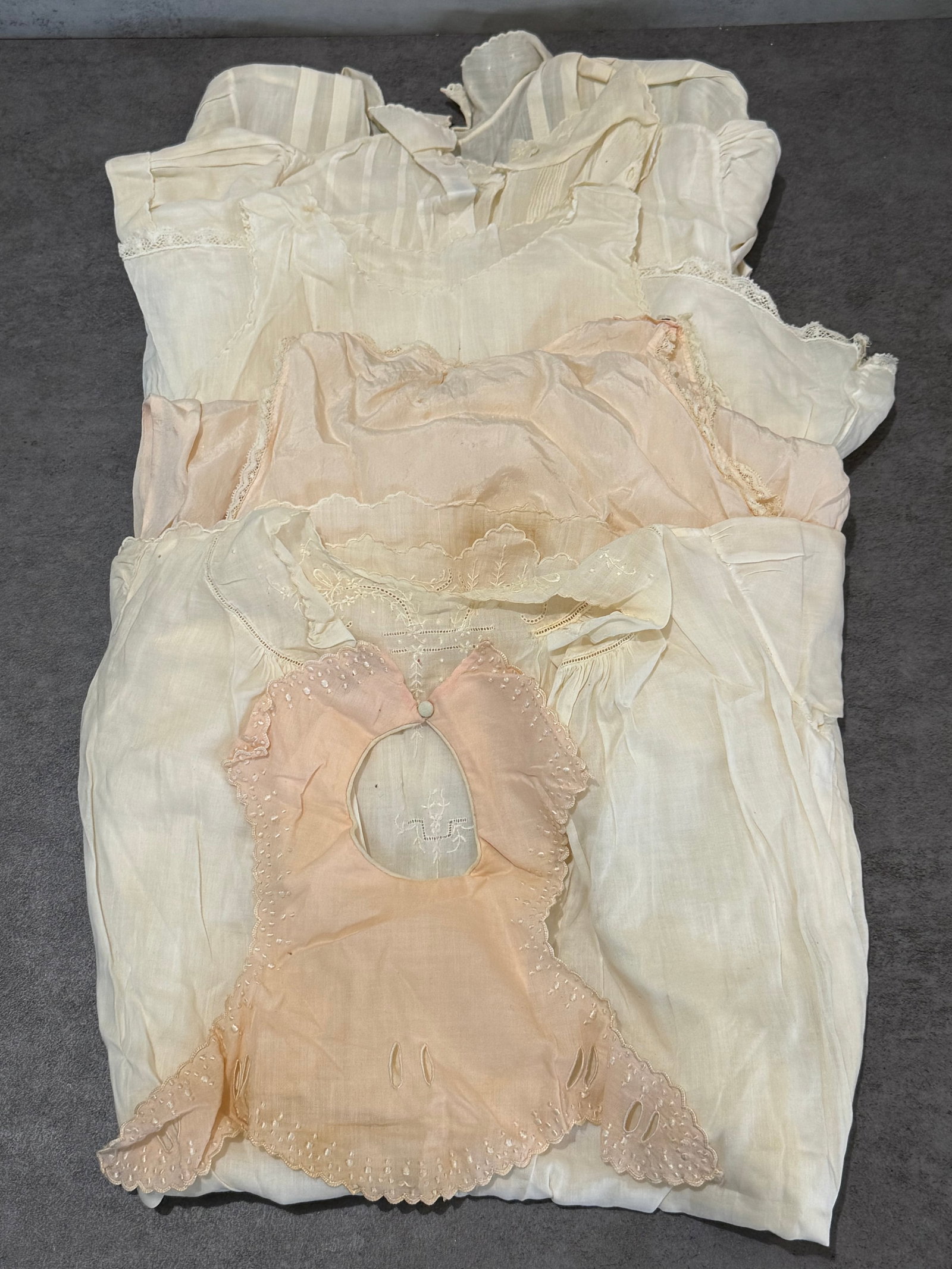 Group of Antique Victorian & Edwardian Child’s Cotton and Silk Night Garments 5+ pieces: A collection of antique Victorian and Edwardian child’s garments including cotton and silk nightwear, infant gowns, and undergarments featuring delicate lace trim, embroidered details, pintuck