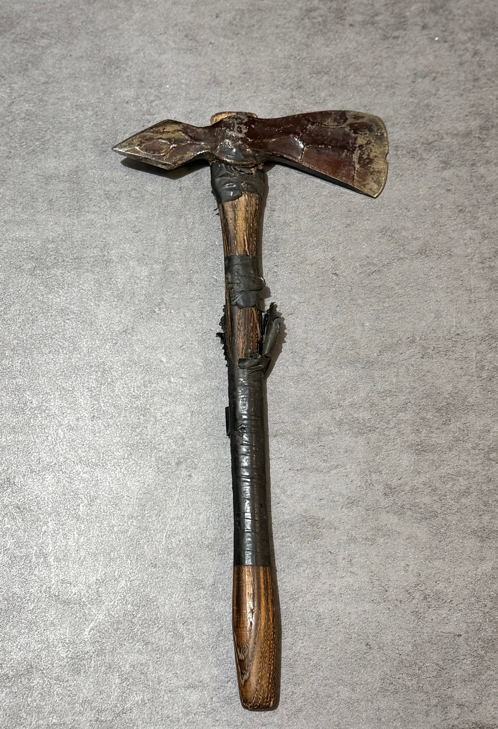 Antique Hand Forged Primitive Iron Hatchet: An antique hand forged primitive iron hatchet mounted on a wooden handle, likely dating to the late 19th to early 20th century. Featuring an unusual sculptural forged head with pointed terminal and