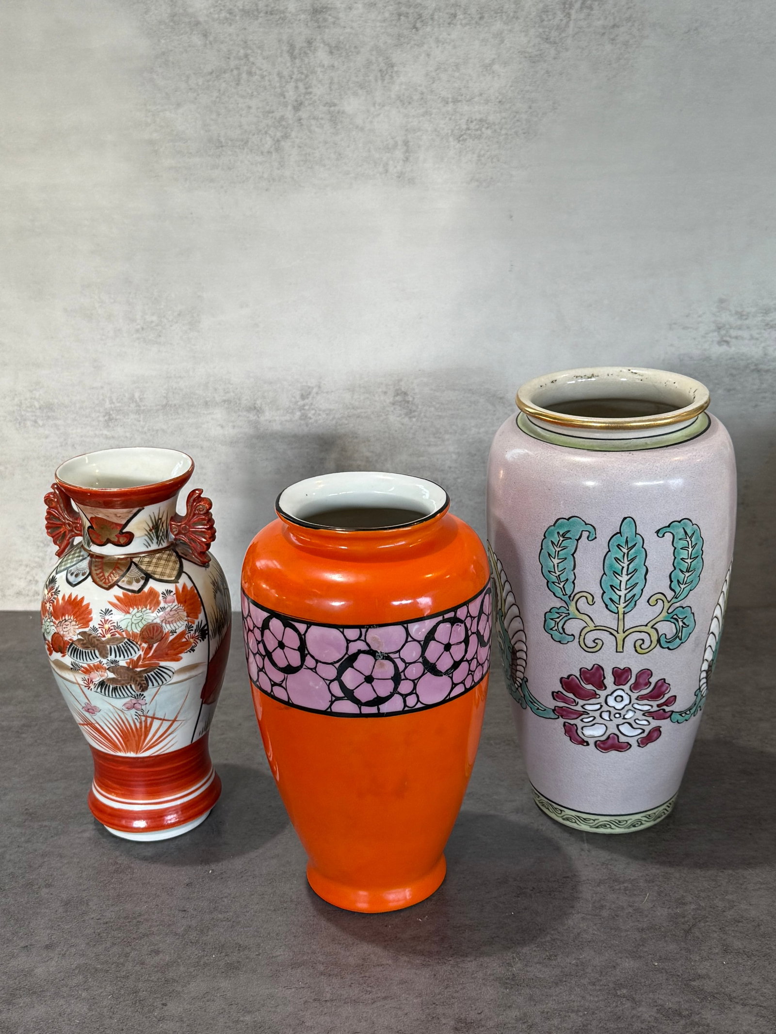 Group of Three Japanese Porcelain Vases: A decorative collection of three Japanese porcelain and ceramic vases featuring a variety of traditional and modern decorative styles. Including an Imari or Kutani style vase with figural and floral d