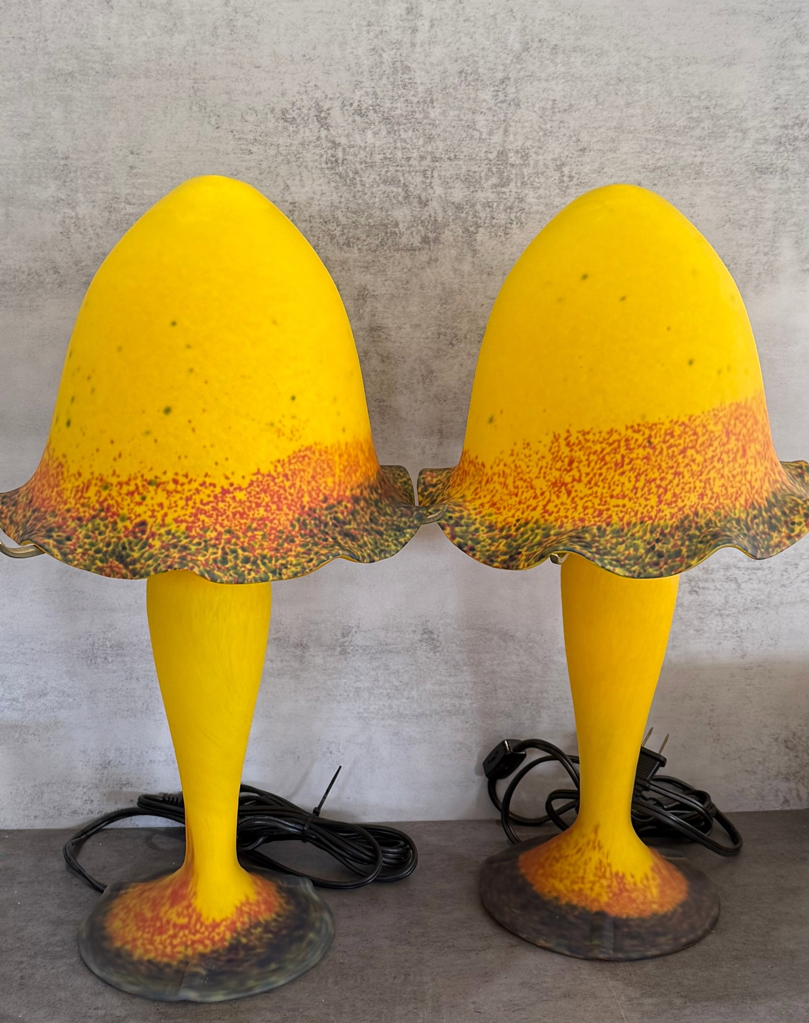 Pair of French Art Deco Mottled Glass Lamps in Tango Taste: A striking pair of French Art Deco style glass lamps of sculptural mushroom form, executed in vibrant mottled coloration with warm yellow, amber, orange, and darker tonal accents. The organically
