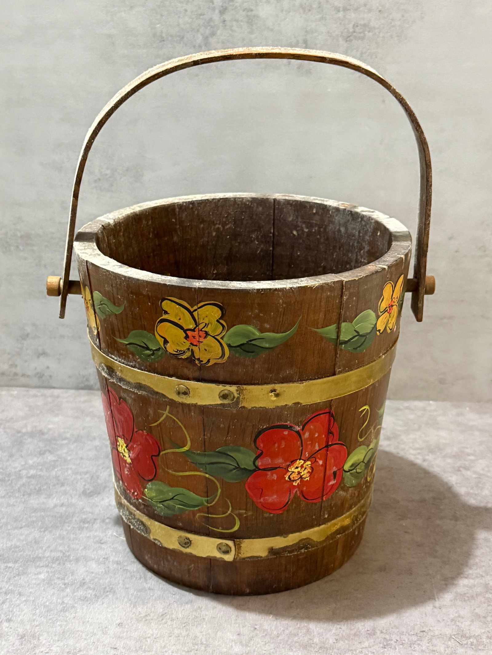 Vintage Hand-Painted Folk Art Wooden Bucket Planter: Vintage wooden bucket or planter featuring hand-painted folk art floral decoration in vivid red, yellow, and green tones against a dark stained wood ground. Constructed in traditional stave form with