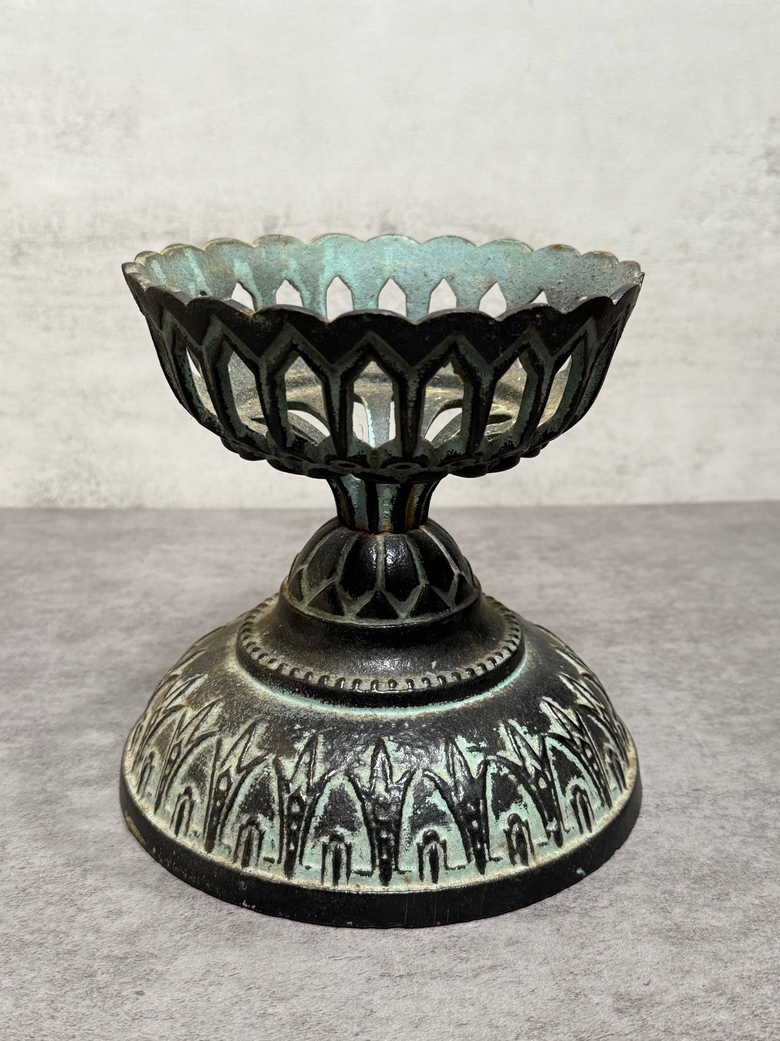 Vintage Gothic Revival Green Cast Iron Pedestal Candle Holder: Decorative cast iron pedestal candle holder featuring pierced Gothic Revival style ornamentation with pointed arch motifs and a verdigris green patinated finish. The elevated bowl-form top is