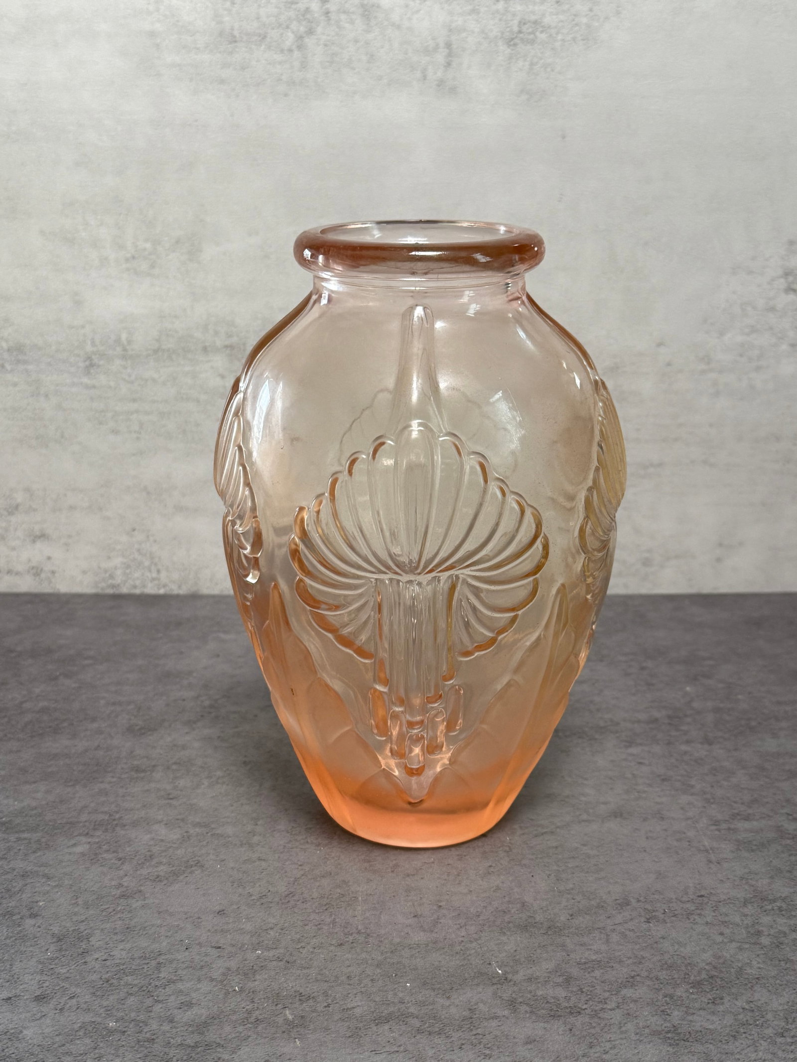 1920’s Art Deco Pierre D’ Avesn Blush Vase calla lily pattern vase: An elegant Art Deco blush glass vase attributed to Pierre D’Avesn, featuring a molded calla lily pattern in relief. The softly frosted peach-toned glass displays a refined geometric silhouette