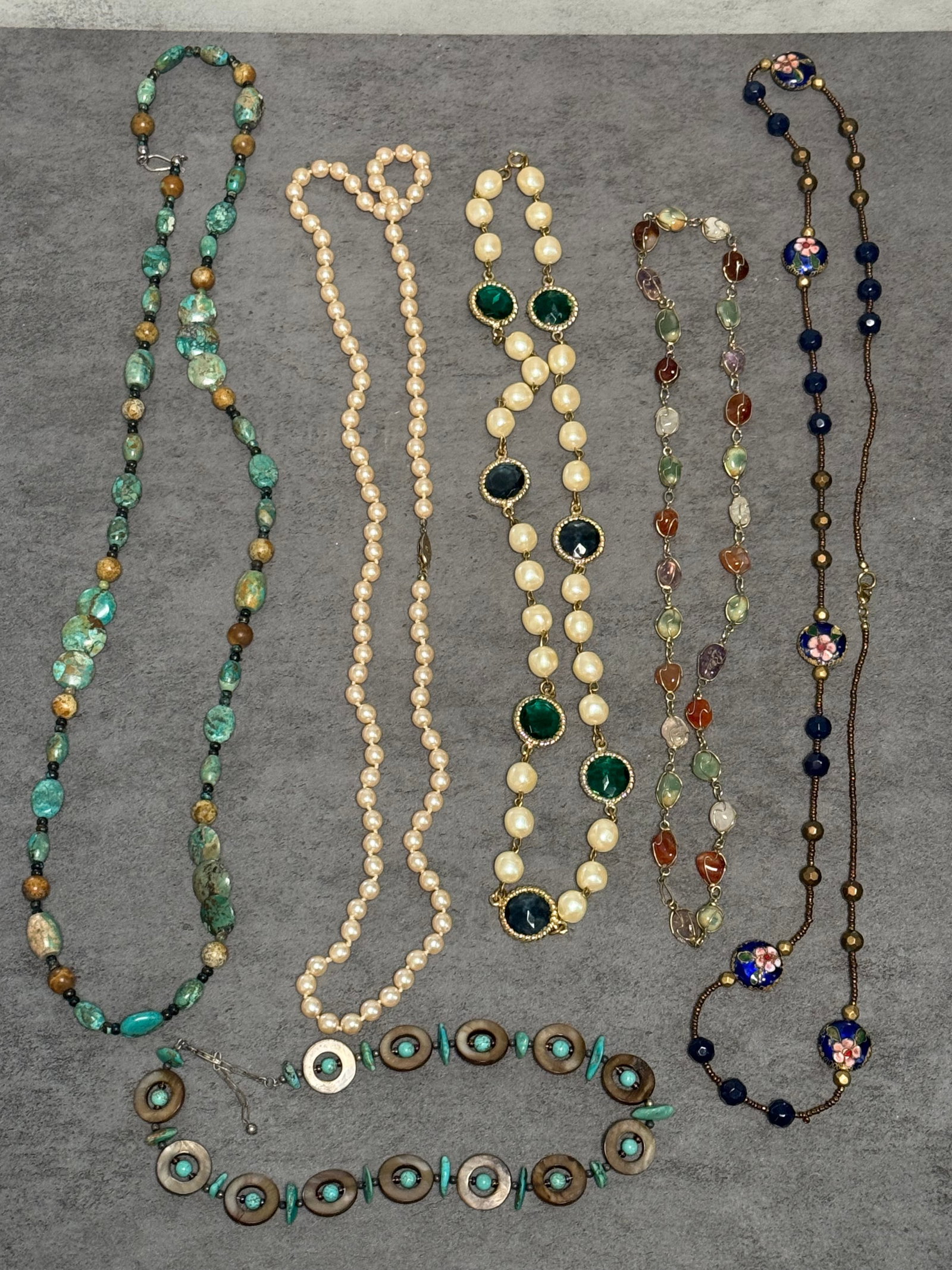 GROUP OF ASSORTED BEADED NECKLACES: A group of assorted costume pearl bead necklaces in varying lengths and styles, including single and multi-strand examples with graduated beads, decorative clasps, and tassel accents. The collection