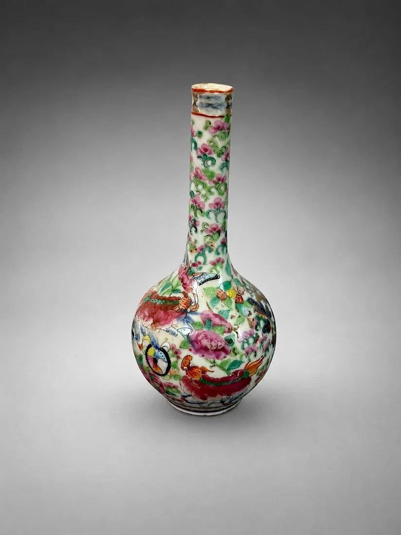 Small Chinese Qing Dynasty Famille Rose Porcelain Bud Vase, 7 Inches: A Chinese Qing Dynasty famille rose porcelain bud vase measuring approximately 7 inches tall. The vase features a classic long-neck bottle form decorated in vibrant famille rose enamels with colorful 