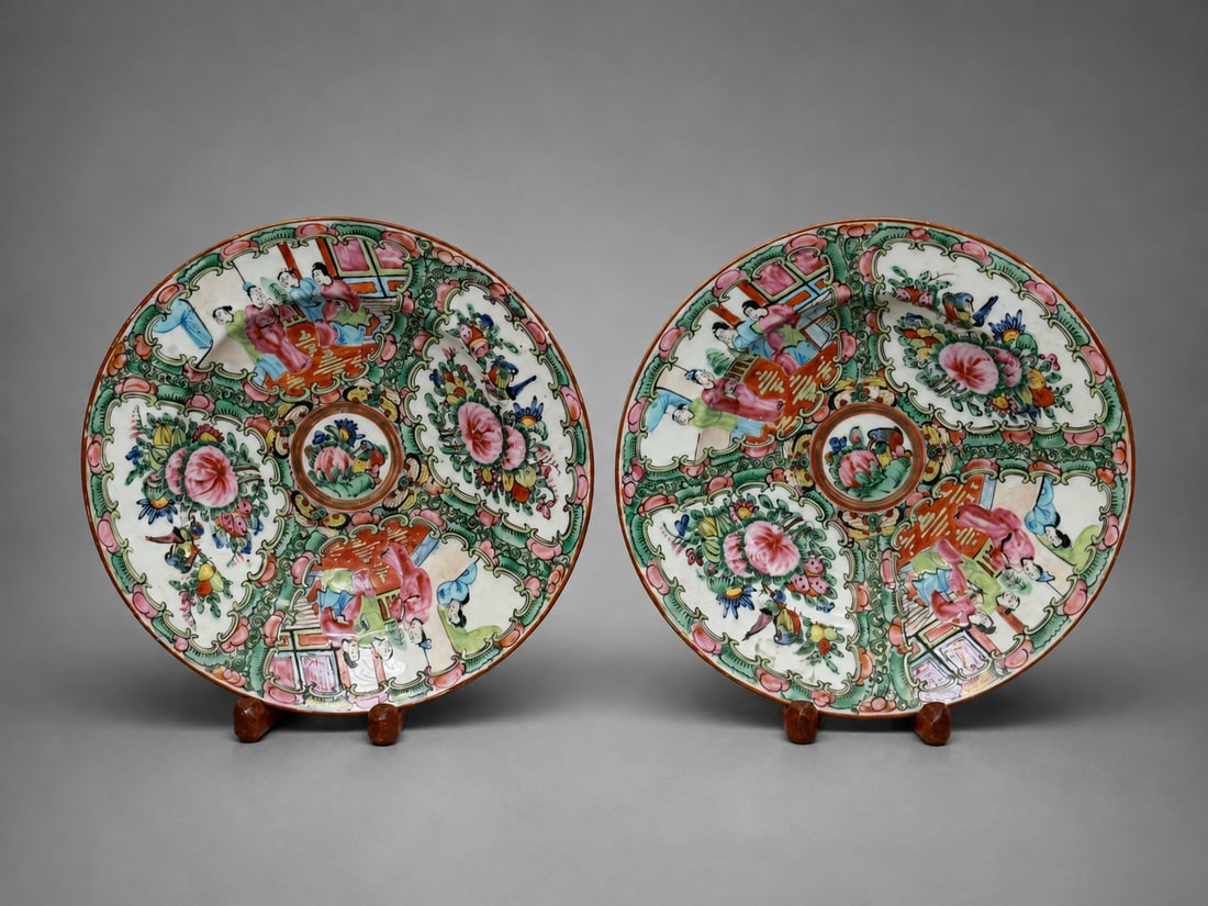 PAIR OF CHINESE ROSE MEDALLION PORCELAIN PLATES: A pair of Chinese porcelain plates decorated in the Rose Medallion palette with alternating figural and floral panels. Each plate features court figures in architectural settings alongside reserves of