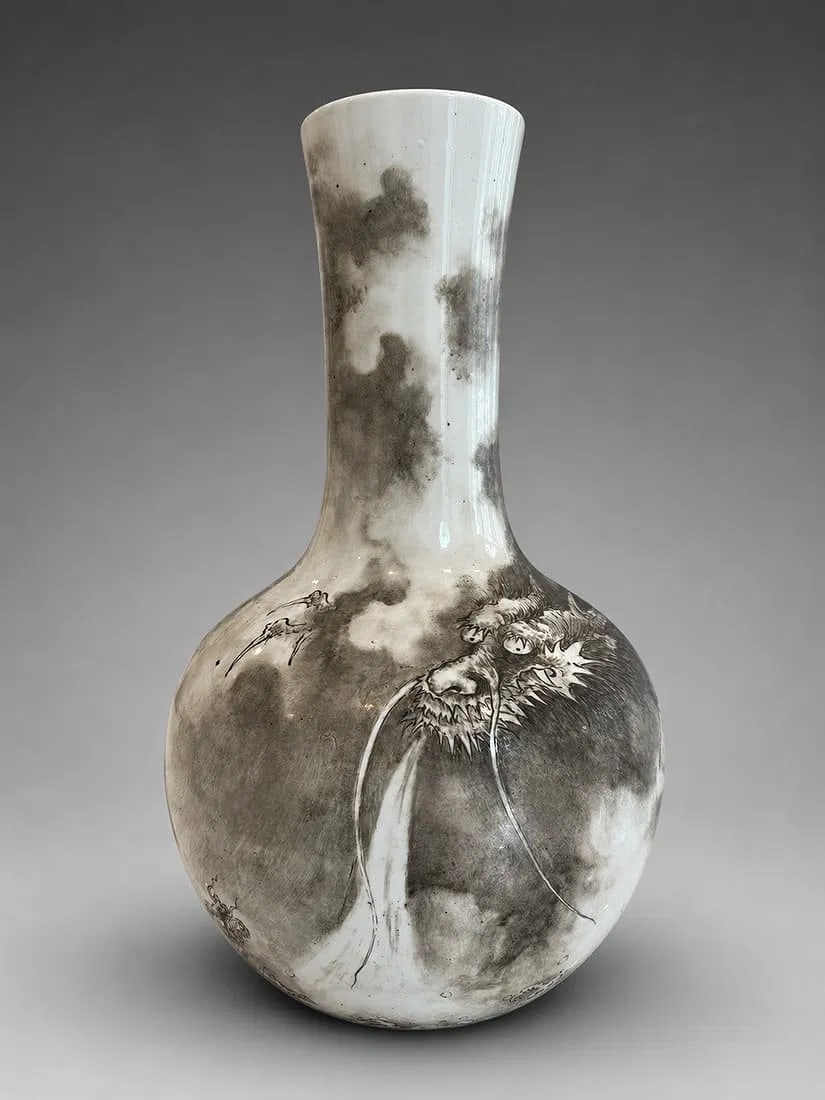 CHINESE EN GRISAILLE PORCELAIN DRAGON BOTTLE VASE: A Chinese porcelain bottle vase of elegant baluster form, decorated in monochrome ink tones with a finely rendered dragon emerging through swirling clouds. Executed using expressive brushwork with sub