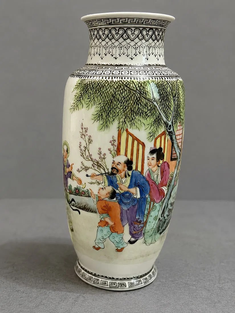 Chinese Famille Rose Porcelain Vase with Figural Decoration: A Chinese Famille Rose porcelain vase decorated with a continuous scene of scholars, attendants, and children gathered in a garden landscape beneath willow trees. Finely hand-painted in vibrant enamel