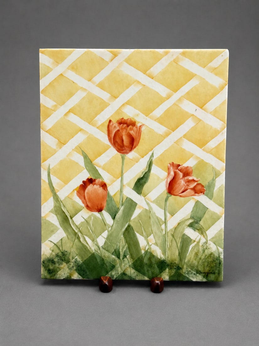 Signed Hand-Painted Ceramic Tulip Plaque: A decorative rectangular ceramic plaque featuring three hand-painted red-orange tulips with green foliage against a yellow and white lattice background. Signed at the lower right. The painted decorati