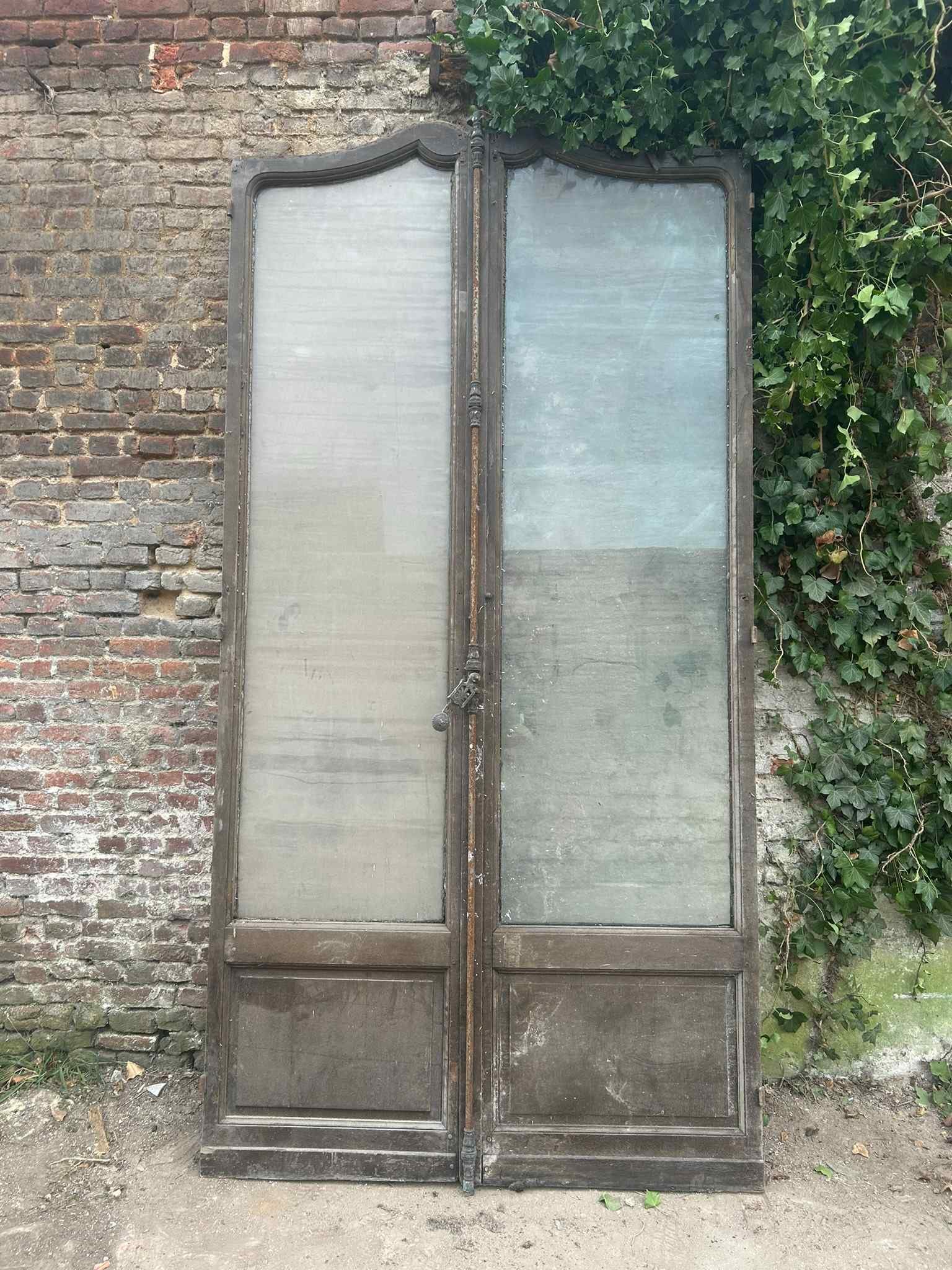 Double door/window in oak with arched stained glass windows and richly decorated door fittings in: Double door/window in oak with arched stained glass windows and richly decorated door fittings in bronze and wrought iron, 19th century H300x152