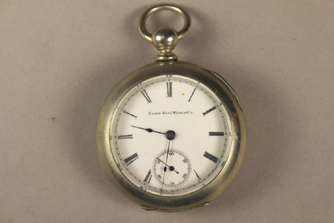 Elgin Pocket Watch in Deuber Silverine Watch Case: Elgin National Watch Co. antique pocket watch, Elgin works #3031076, enameled face with blue hands with Deuber Watch Case Co. silverine case. D. 2.25". Overall good condition.
