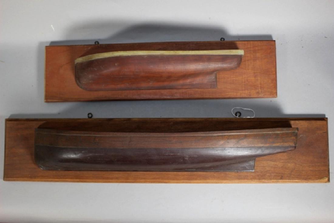 Two Walnut Half Hull Ship Models: Two different ships half hulls mounted on a wood plaque. One Hull 3'' x 16'' other 3'' x 23''.