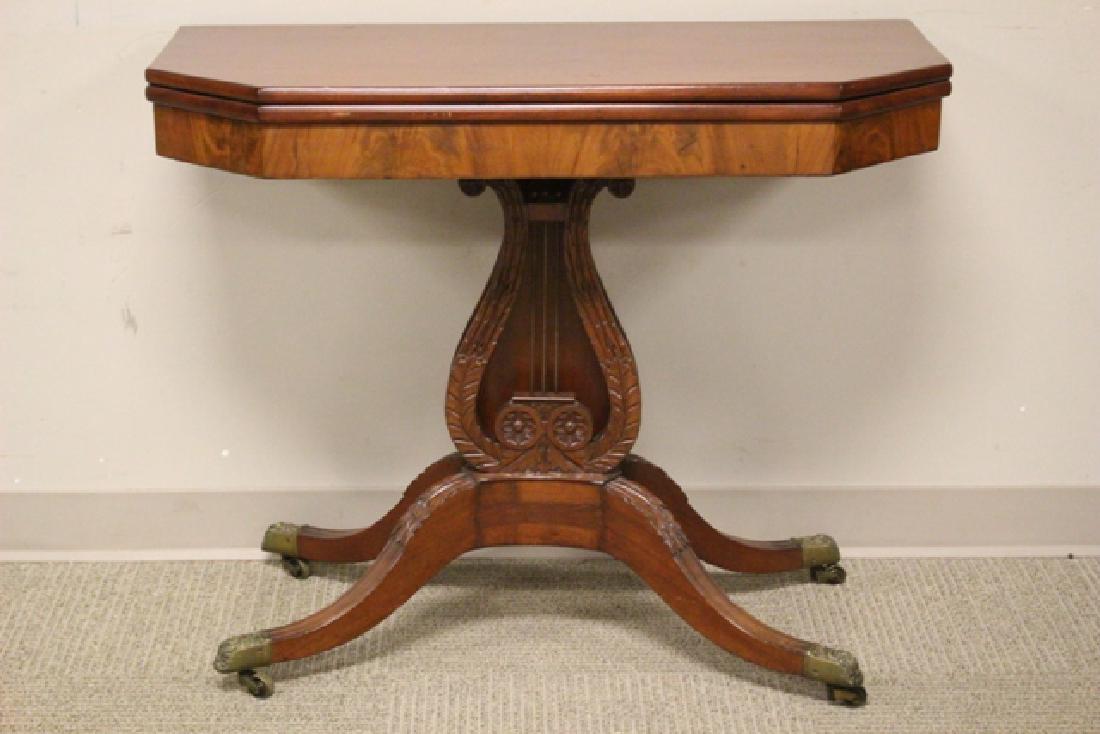 Period Mahogany Duncan Phyfe Game Table: Fine flip top game table with carved harp / liar center column ending in ornate brass feet. Condition very good, old repair on top by hinge, older partial refinish. H. 29'' W. 31'' D. 18'' open 36''