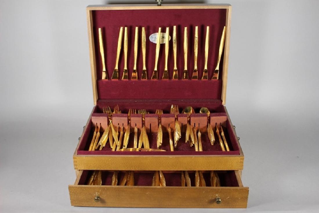 Service for 16 Gold Plated Fashion Manor Flatware: Including 16 salad forks, dinner forks, spoons, large spoons, knives. Normal use and wear in mahogany case.