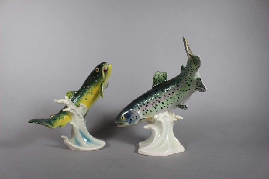 2 Goebel Trout Fish Figurines: Porcelain figurines by Goebel, one being a brook trout and the slightly larger one a rainbow trout. Both in good overall condition. Standing approx 8.75" tall and the smaller brook trout approx 7" tal