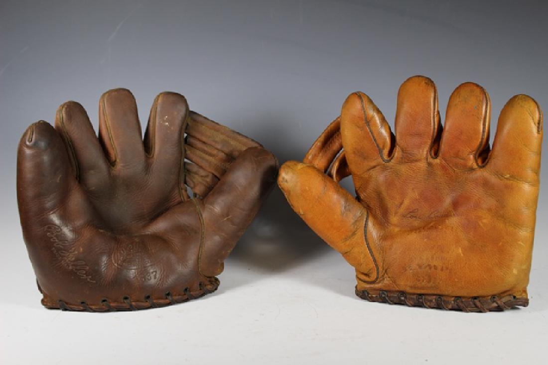 1940's Cleveland Indians Hall of Famer Baseball Gloves: Store models. Included is a Bob Feller J.C. Higgins Sears and Roebuck model #1637. Scarce lefty glove (fits on right hand). No rips or tears. No writing. The other is an Olympia Lou Boudreau buckle-ba