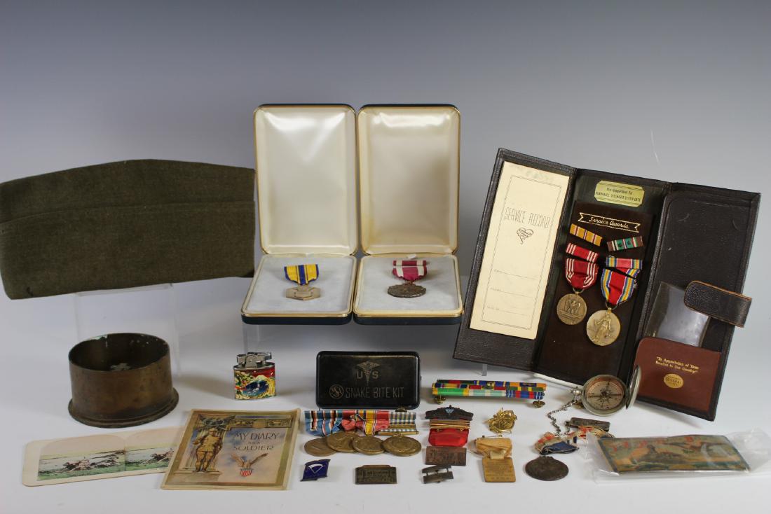 Military Medals And Misc.: Including 14 medals and pins,U.S. issued snake bite kit, lighter, compass, hat, misc. paper, Honorable Discharge Awards and MK3 base. All in good age appropriate condition, see photos.
