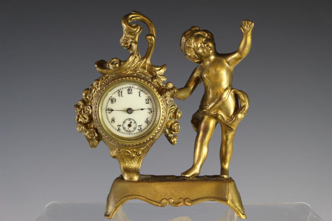 19th Century FRENCH Dore Gilt Desk Clock: 19th century French clock with cherub in dore. Approx. 7" x 6". Fire gilt finish. Good condition as shown. Currently working.