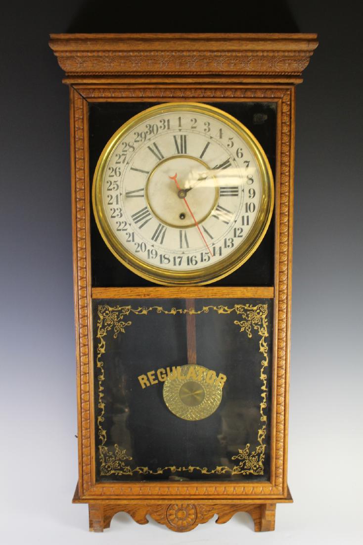 Oak Sessions Tall Case Regulator Clock: 19th century clock features a solid oak case and a mechanical movement. The clock face shows the 31 day numbers on the outer edge and the 12 hours in Roman numerals on the inside. The clock face is ma