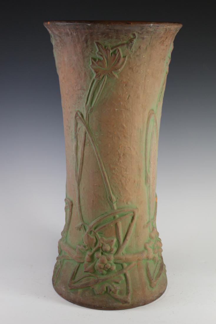 Peters and Reed Zanesville Umbrella Stand: Zanesville Umbrella Stand or can holder signed by the artist as shown, attributed to red clay or terracotta Peters and Reed 24" tall x 12" dia. Finished turned glaze interior. Minor loss see photos fo