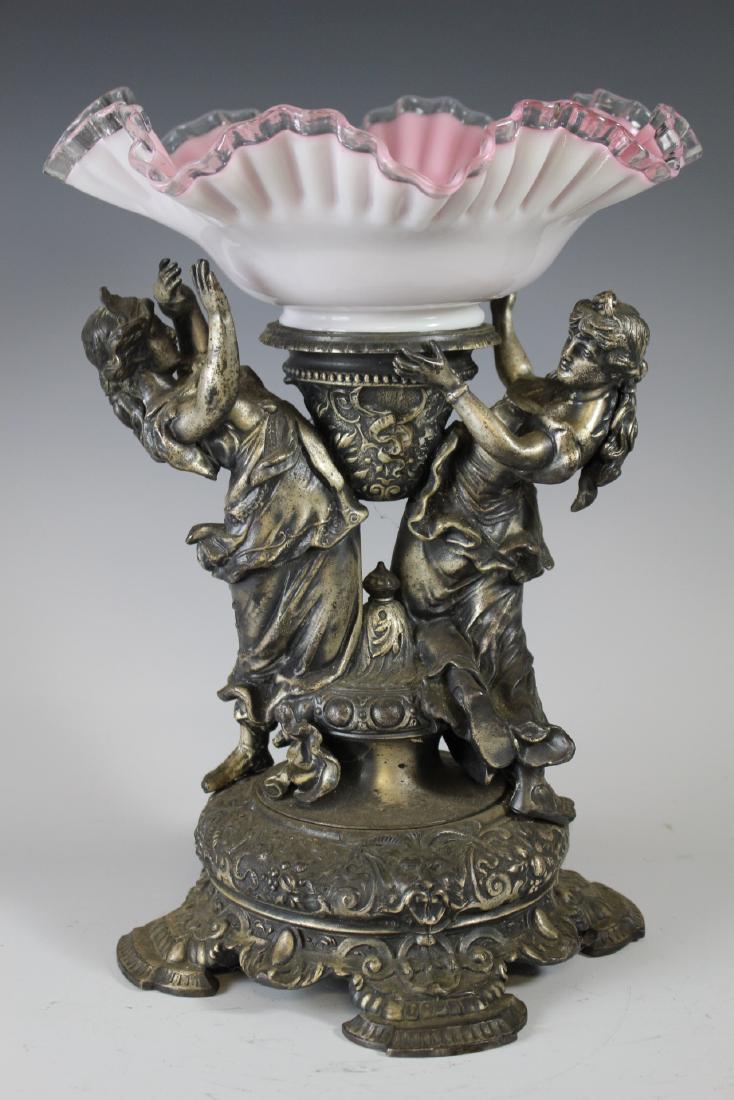 19th Century Victorian Figural Compote: Very fine cast metal double figural compote of two goddess like women on renaissance footed base. Pink silver crested ruffled glass bowl. Measuring approx. 15" tall. Two piece assembled. Wonderfully e