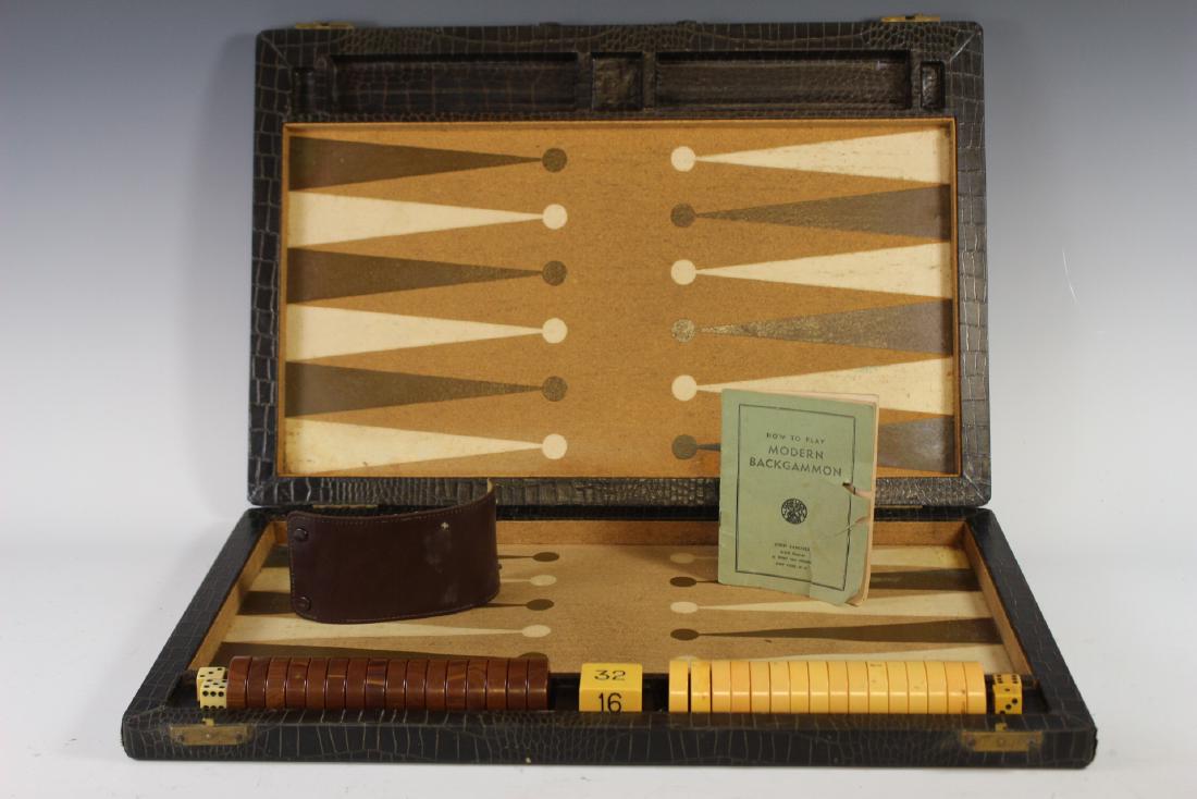 Early 20th Century Backgammon Traveling Set: Complete 20th century Backgammon set with original rule book. Approx. 23" by 30". In good age appropriate condition. Note; leather dice cup needs repair to one of the clasps, rule book does have some 